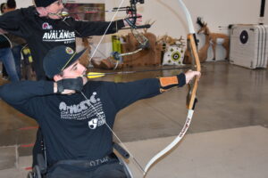 A man enjoying archery at RMS Gear with the River Deep Foundation 