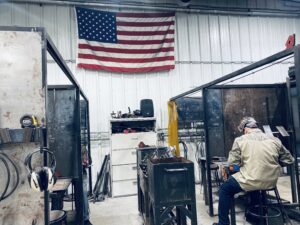 Man works on project at Kilroy's under American flag